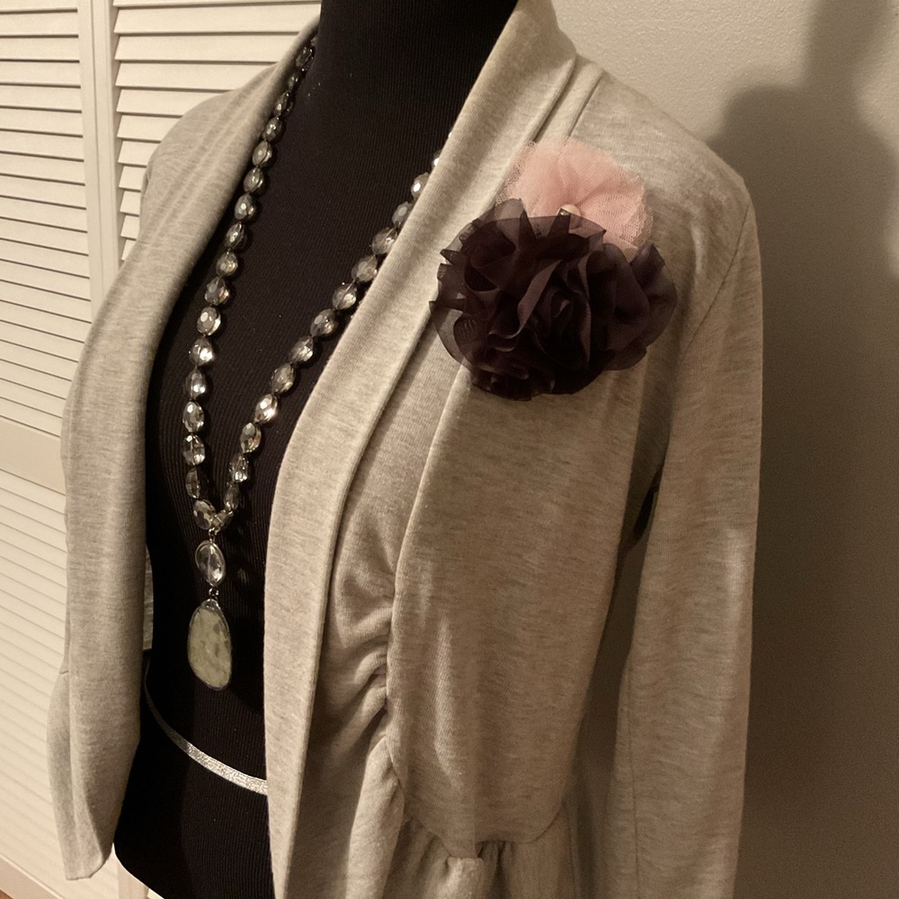 Beautiful light gray sweater, pink and black flowers. Necklace not for sale.